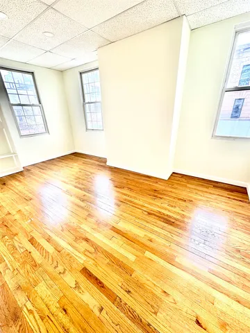 a view of an empty room and wooden floor