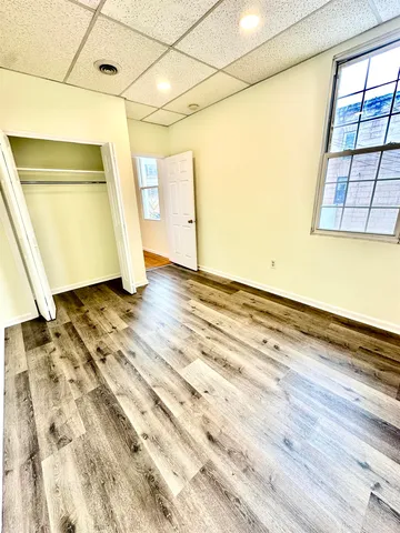 a view of a room with wooden floor