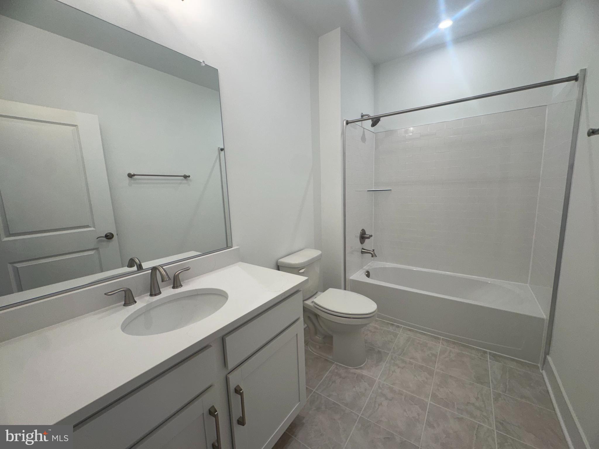 82 Valerian Loop, Unit 2 Stafford, VA 22554 - Photo 13 of 55 a bathroom with a granite countertop sink toilet and shower