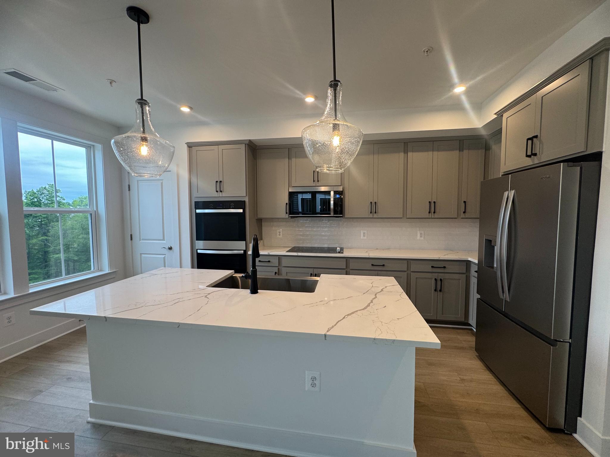 82 Valerian Loop, Unit 2 Stafford, VA 22554 - Photo 4 of 55 a kitchen with kitchen island a counter space a sink appliances and a window