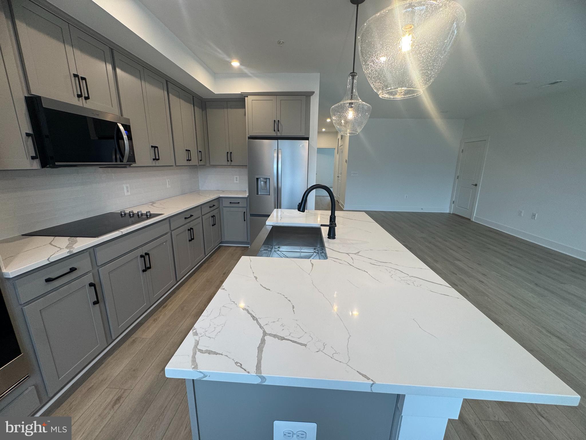 82 Valerian Loop, Unit 2 Stafford, VA 22554 - Photo 6 of 55 a kitchen with granite countertop a sink a stove and cabinets