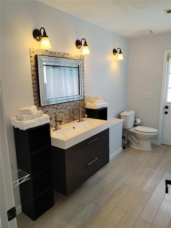 7607 Benji Ridge Trail Kissimmee, FL 34747 - Photo 11 of 58 a bathroom with a sink vanity mirror and toilet