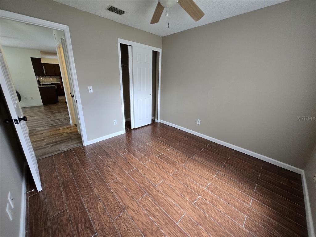 7607 Benji Ridge Trail Kissimmee, FL 34747 - Photo 15 of 58 wooden floor in a hall with an entryway