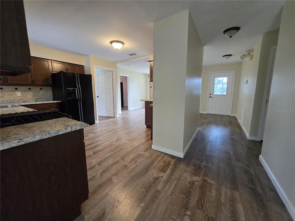 7607 Benji Ridge Trail Kissimmee, FL 34747 - Photo 17 of 58 a view of a kitchen from the hallway