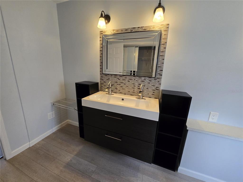 7607 Benji Ridge Trail Kissimmee, FL 34747 - Photo 19 of 58 a bathroom with a sink vanity and mirror