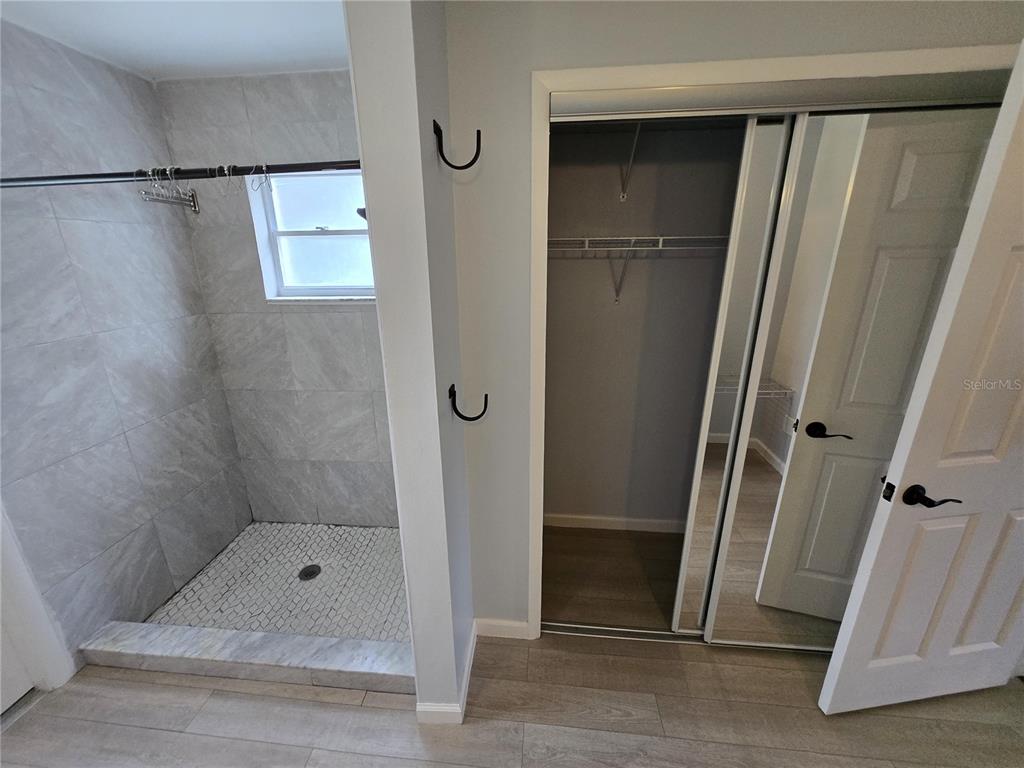 7607 Benji Ridge Trail Kissimmee, FL 34747 - Photo 20 of 58 a bathroom with a glass door shower