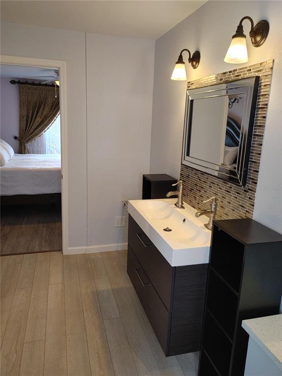 7607 Benji Ridge Trail Kissimmee, FL 34747 - Photo 21 of 58 a bathroom with a sink and mirror