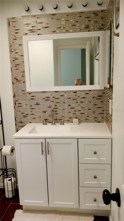 7607 Benji Ridge Trail Kissimmee, FL 34747 - Photo 23 of 58 a bathroom with a sink and a mirror
