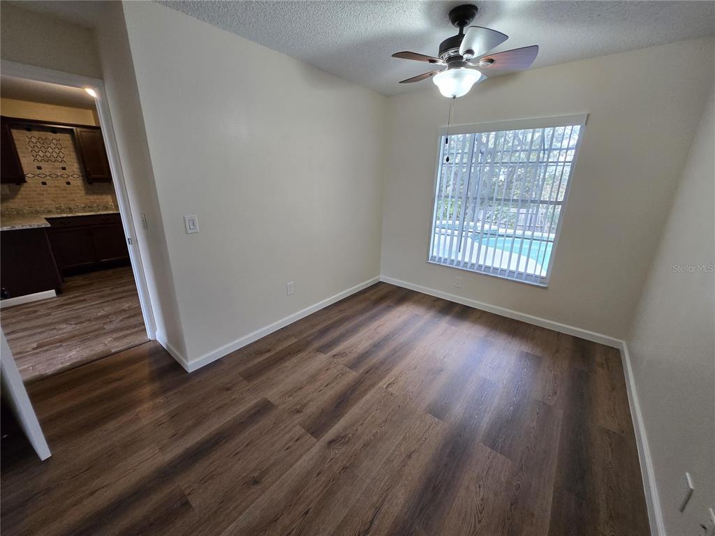 7607 Benji Ridge Trail Kissimmee, FL 34747 - Photo 24 of 58 wooden floor in an empty room with a window