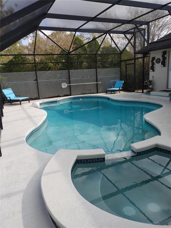 7607 Benji Ridge Trail Kissimmee, FL 34747 - Photo 27 of 58 a view of a swimming pool with a sitting space
