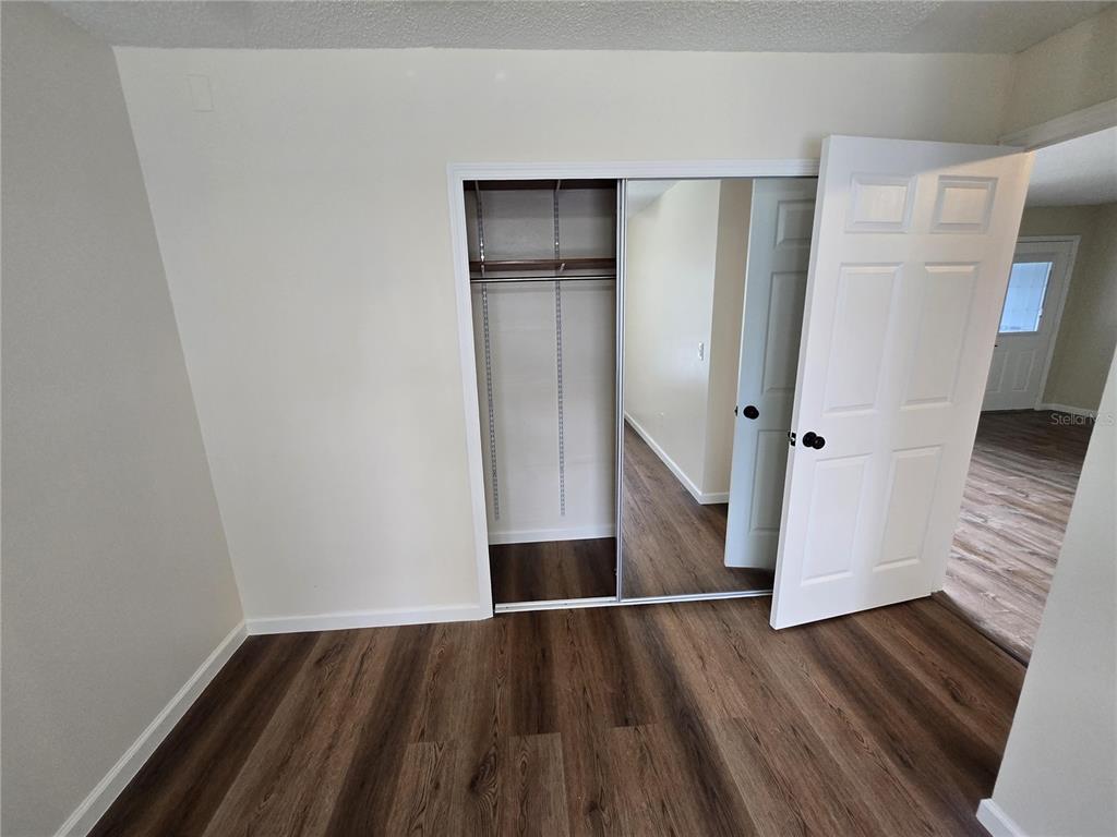7607 Benji Ridge Trail Kissimmee, FL 34747 - Photo 29 of 58 a view of an empty room with wooden floor and a sink