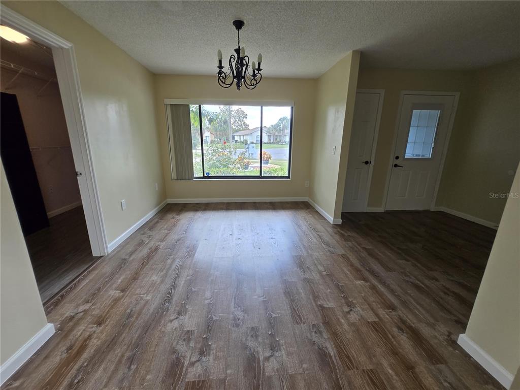 7607 Benji Ridge Trail Kissimmee, FL 34747 - Photo 31 of 58 wooden floor in an empty room with a window