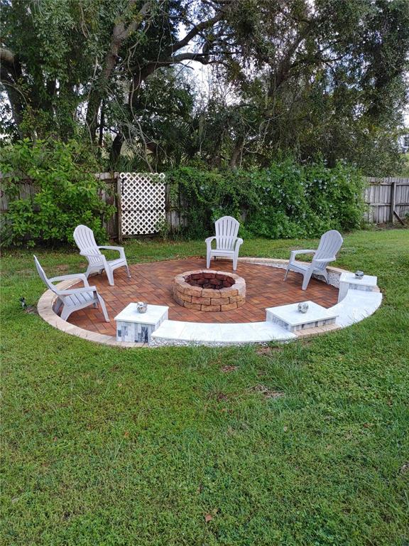 7607 Benji Ridge Trail Kissimmee, FL 34747 - Photo 40 of 58 a view of a table and chairs in the garden