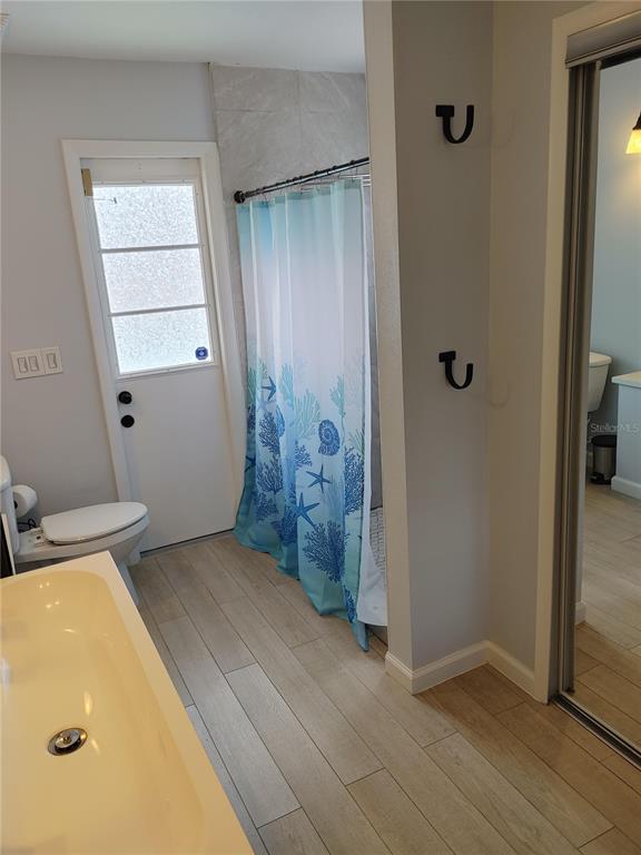 7607 Benji Ridge Trail Kissimmee, FL 34747 - Photo 4 of 58 wooden floor and chair in a room