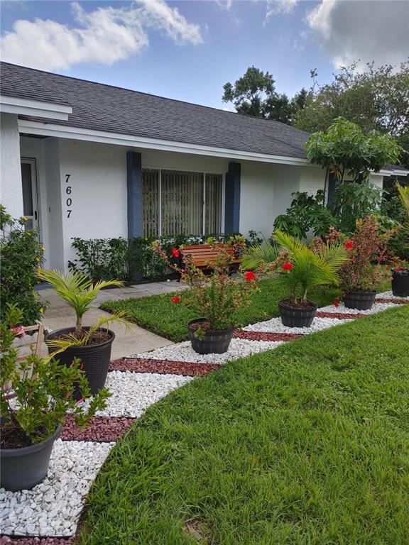 7607 Benji Ridge Trail Kissimmee, FL 34747 - Photo 41 of 58 a view of a house with a garden and plants