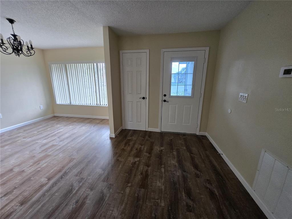 7607 Benji Ridge Trail Kissimmee, FL 34747 - Photo 47 of 58 an empty room with wooden floor and windows