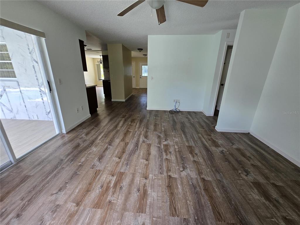 7607 Benji Ridge Trail Kissimmee, FL 34747 - Photo 6 of 58 wooden floor in an empty room with a window
