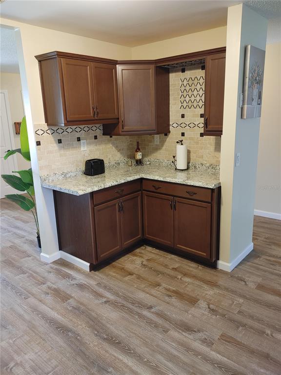 7607 Benji Ridge Trail Kissimmee, FL 34747 - Photo 8 of 58 a kitchen with stainless steel appliances granite countertop a sink stove and refrigerator
