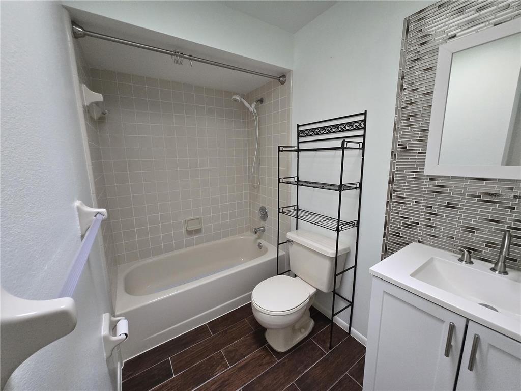 7607 Benji Ridge Trail Kissimmee, FL 34747 - Photo 10 of 58 a bathroom with a toilet sink and a bathtub