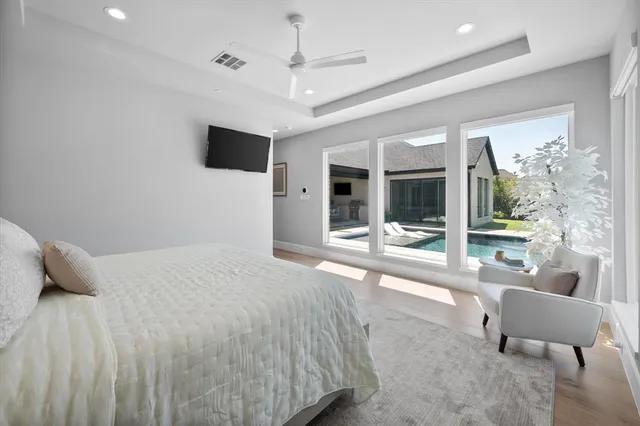 a bedroom with a bed and glass door