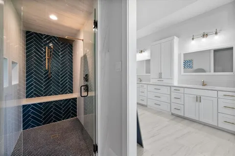 a view of walk in closet and bathroom