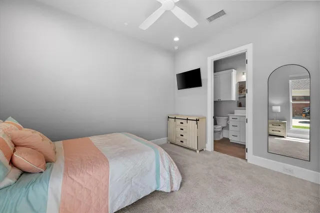 a bedroom with a bed and a television