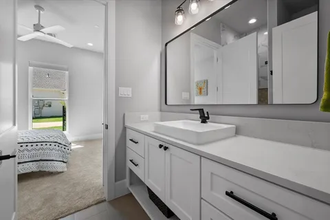 a spacious bathroom with a double vanity sink a mirror and a bathtub