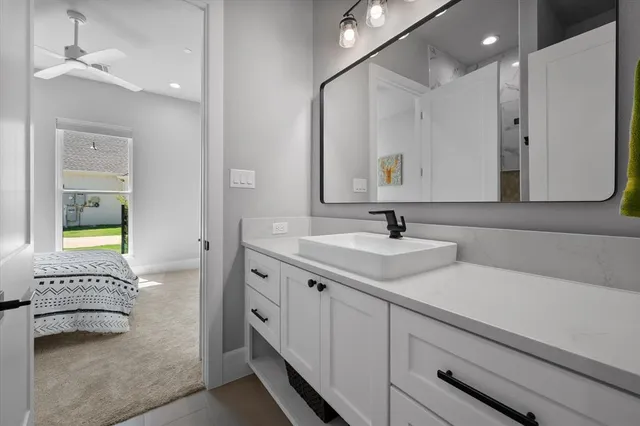a spacious bathroom with a double vanity sink a mirror and a bathtub