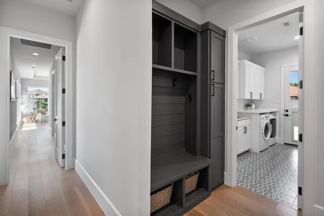 a view of a hallway with bathroom and wooden floor