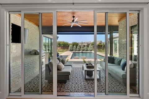 a living room with furniture and a floor to ceiling window