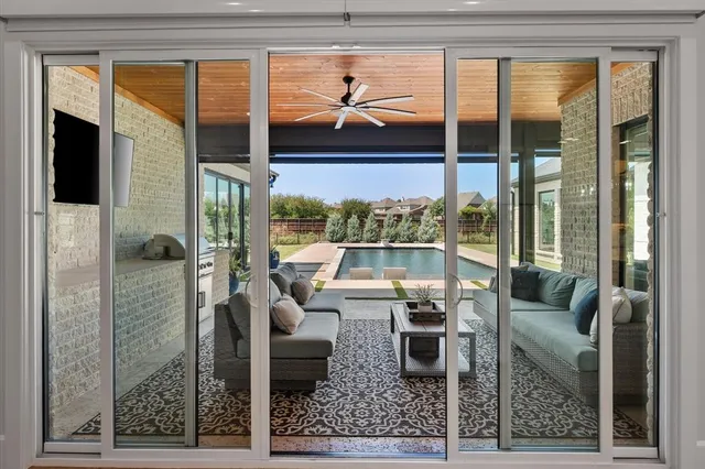 a living room with furniture and a floor to ceiling window