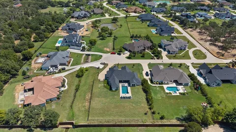 an aerial view of residential houses with outdoor space and parking