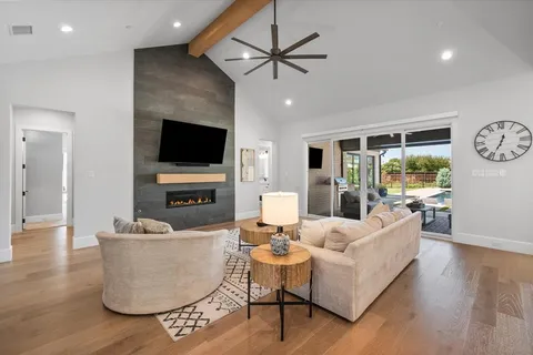 a living room with fireplace furniture and a flat screen tv