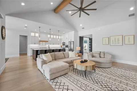a living room with furniture and kitchen view