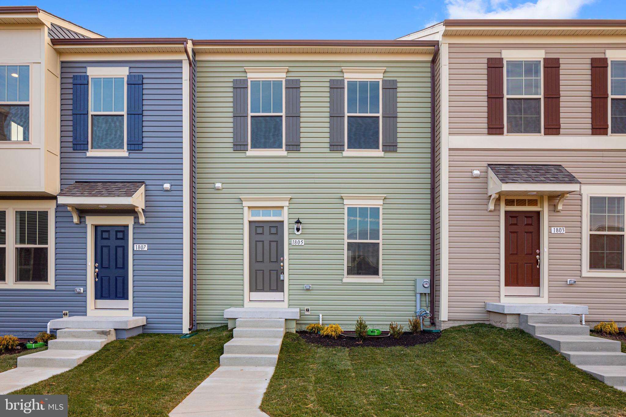 a view of a house with a small yard and a large window