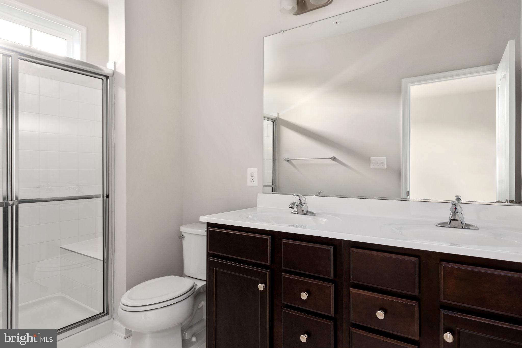 1805 Evans Road Frederick, MD 21702 - Photo 13 of 21 a bathroom with a sink a toilet a mirror and shower