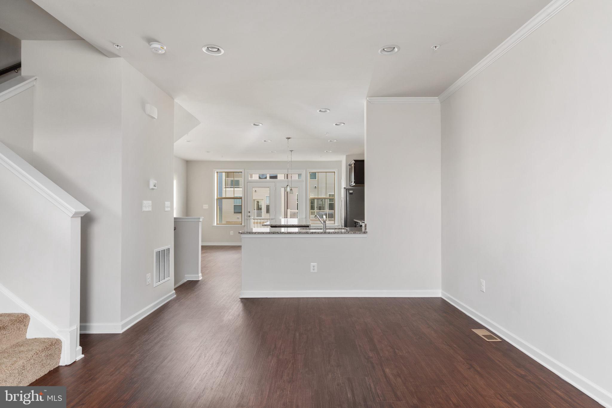 1805 Evans Road Frederick, MD 21702 - Photo 2 of 21 a view of a big room with wooden floor and windows