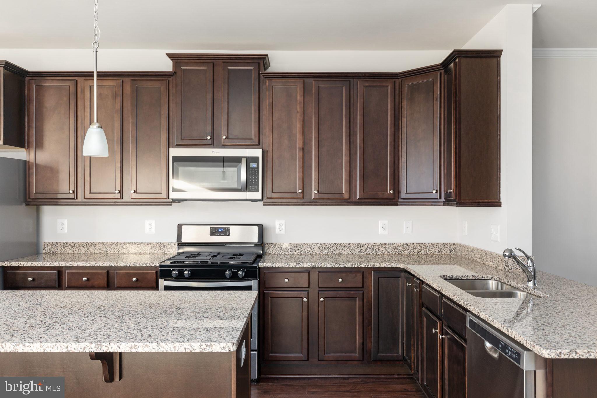 1805 Evans Road Frederick, MD 21702 - Photo 5 of 21 a kitchen with granite countertop a sink stove and cabinets