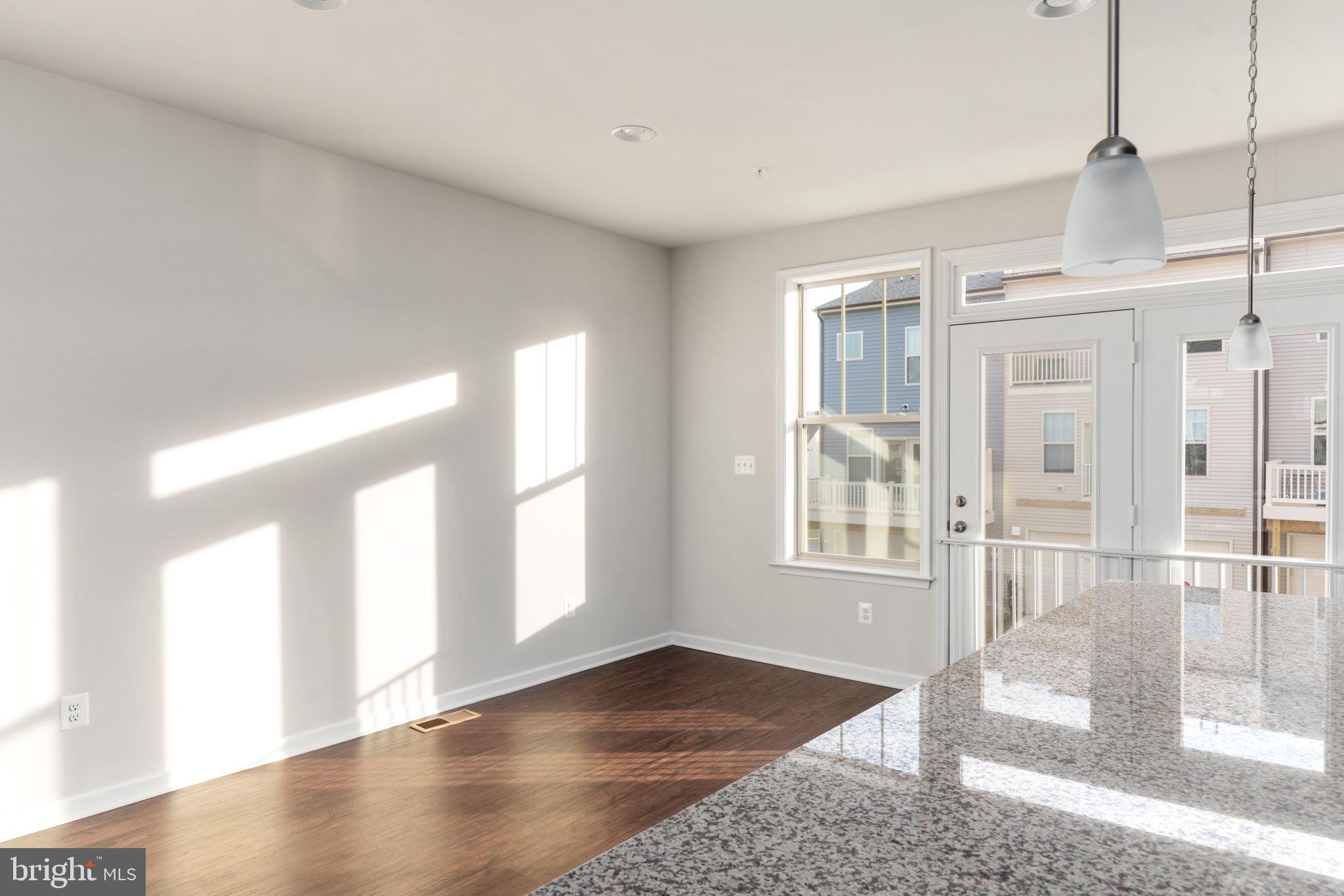 1805 Evans Road Frederick, MD 21702 - Photo 6 of 21 a view of an empty room with wooden floor and windows