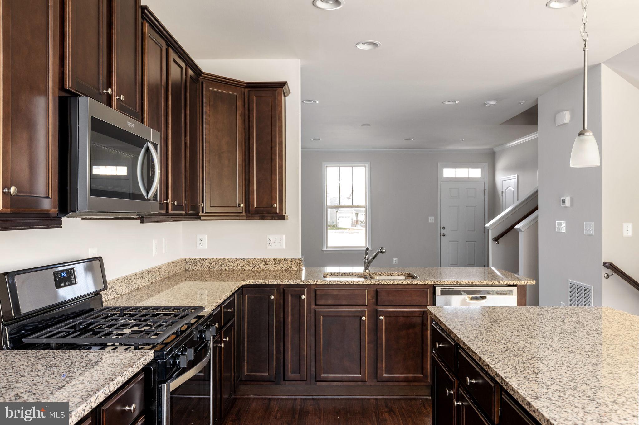 1805 Evans Road Frederick, MD 21702 - Photo 8 of 21 a kitchen with stainless steel appliances granite countertop a sink stove and cabinets
