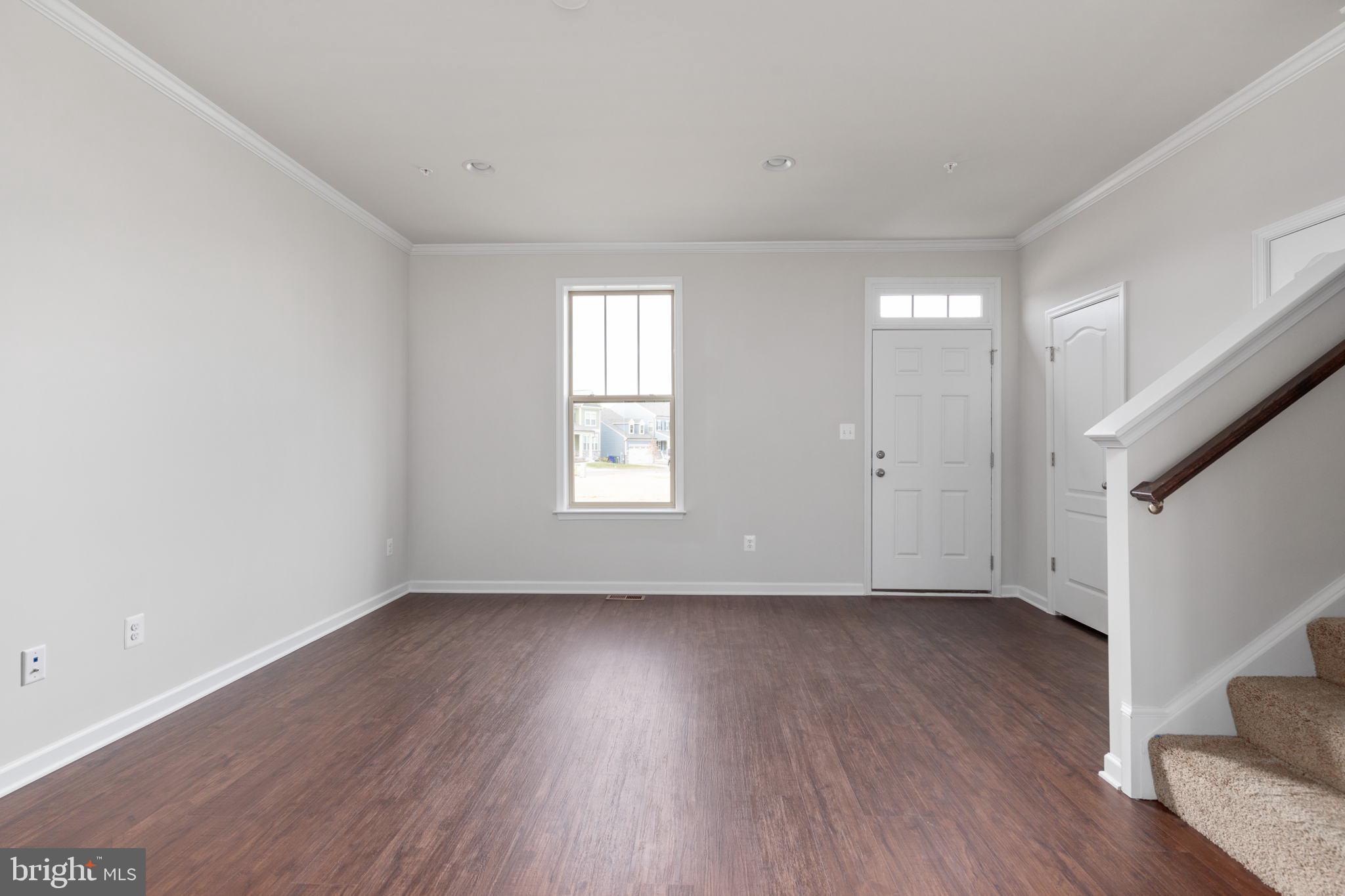 1805 Evans Road Frederick, MD 21702 - Photo 9 of 21 an empty room with wooden floor and windows
