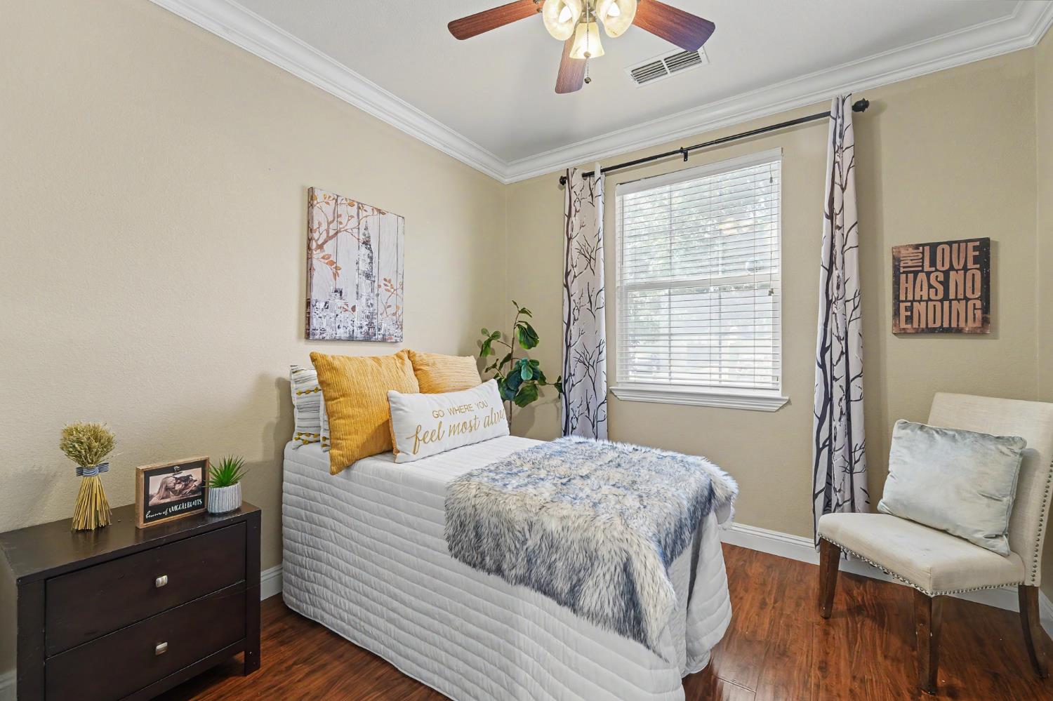 1223 East Springer Drive Turlock, CA 95382 - Photo 36 of 48 a bedroom with a bed and a chandelier