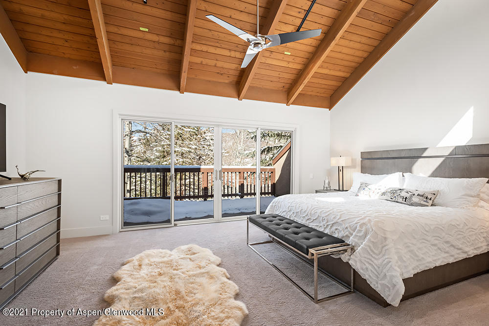 800 Ridge Road, Unit 12 Snowmass Village, CO 81615 - Photo 14 of 27 a bedroom with a bed and a window