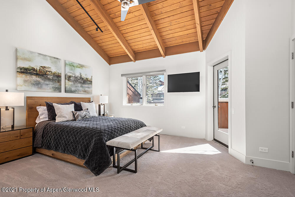 800 Ridge Road, Unit 12 Snowmass Village, CO 81615 - Photo 18 of 27 a bedroom with a bed and a large window