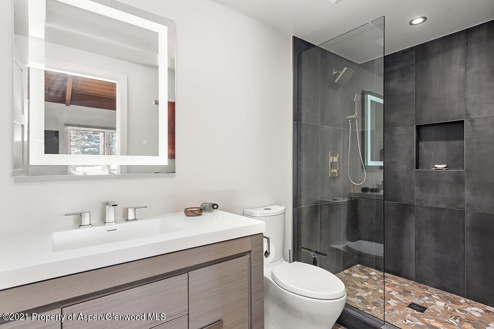 800 Ridge Road, Unit 12 Snowmass Village, CO 81615 - Photo 19 of 27 a bathroom with a sink toilet and shower