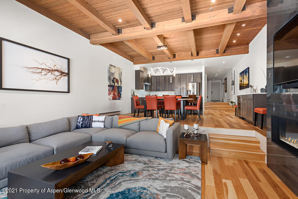 800 Ridge Road, Unit 12 Snowmass Village, CO 81615 - Photo 3 of 27 a living room with furniture and a flat screen tv