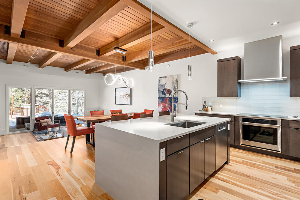 800 Ridge Road, Unit 12 Snowmass Village, CO 81615 - Photo 6 of 27 a kitchen with sink a stove and chairs