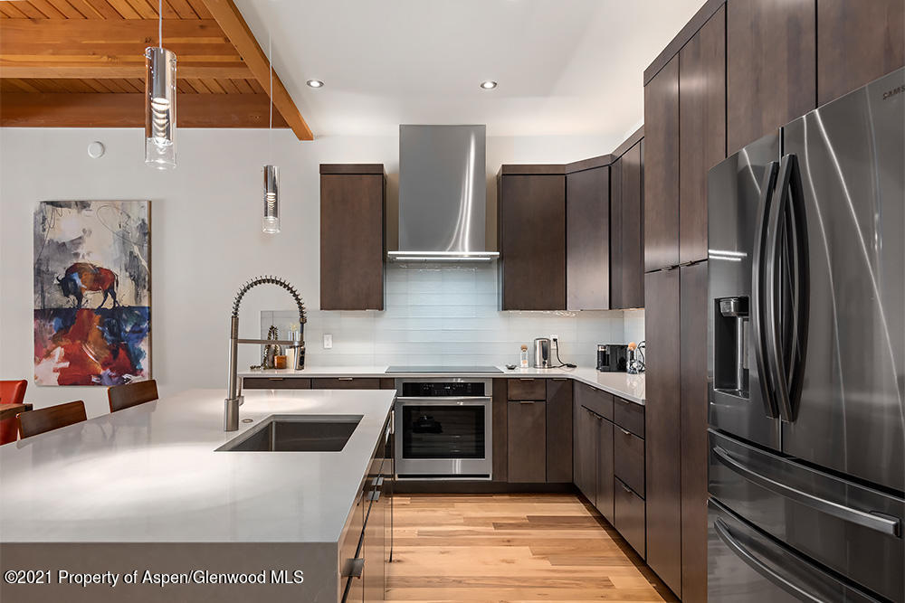 800 Ridge Road, Unit 12 Snowmass Village, CO 81615 - Photo 7 of 27 a kitchen with stainless steel appliances a sink stove and refrigerator