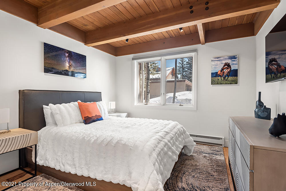 800 Ridge Road, Unit 12 Snowmass Village, CO 81615 - Photo 8 of 27 a bedroom with a bed and a window