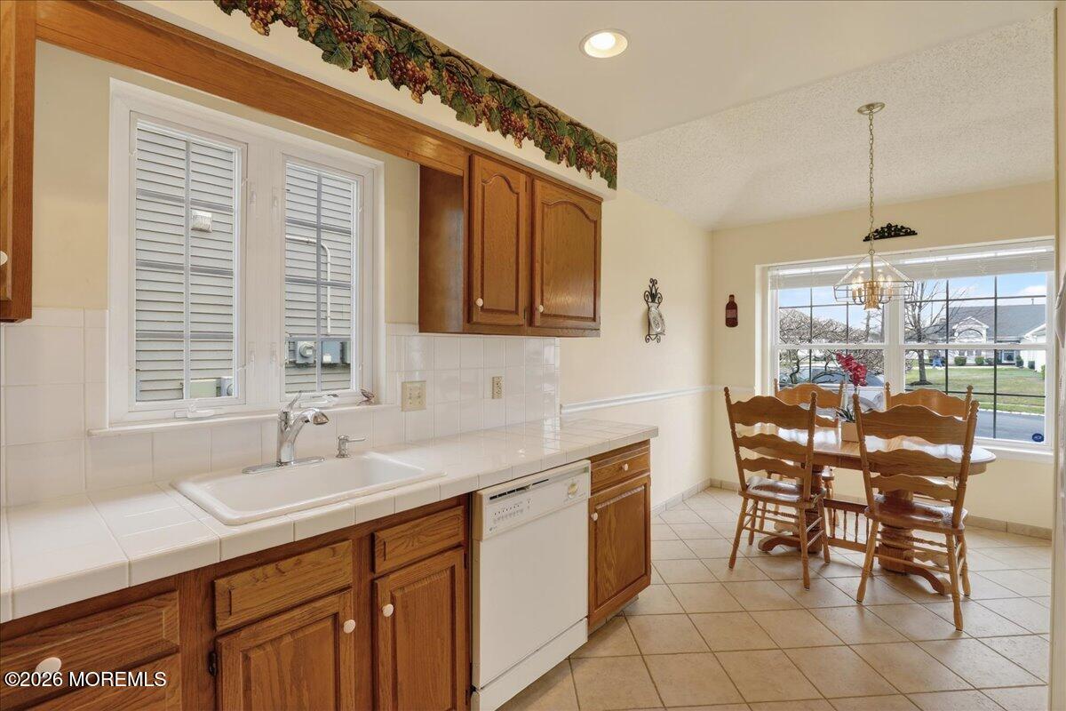 18 Angus Court Jackson, NJ 08527 - Photo 12 of 45 a dining hall with stainless steel appliances a sink dishwasher and cabinets with wooden floor